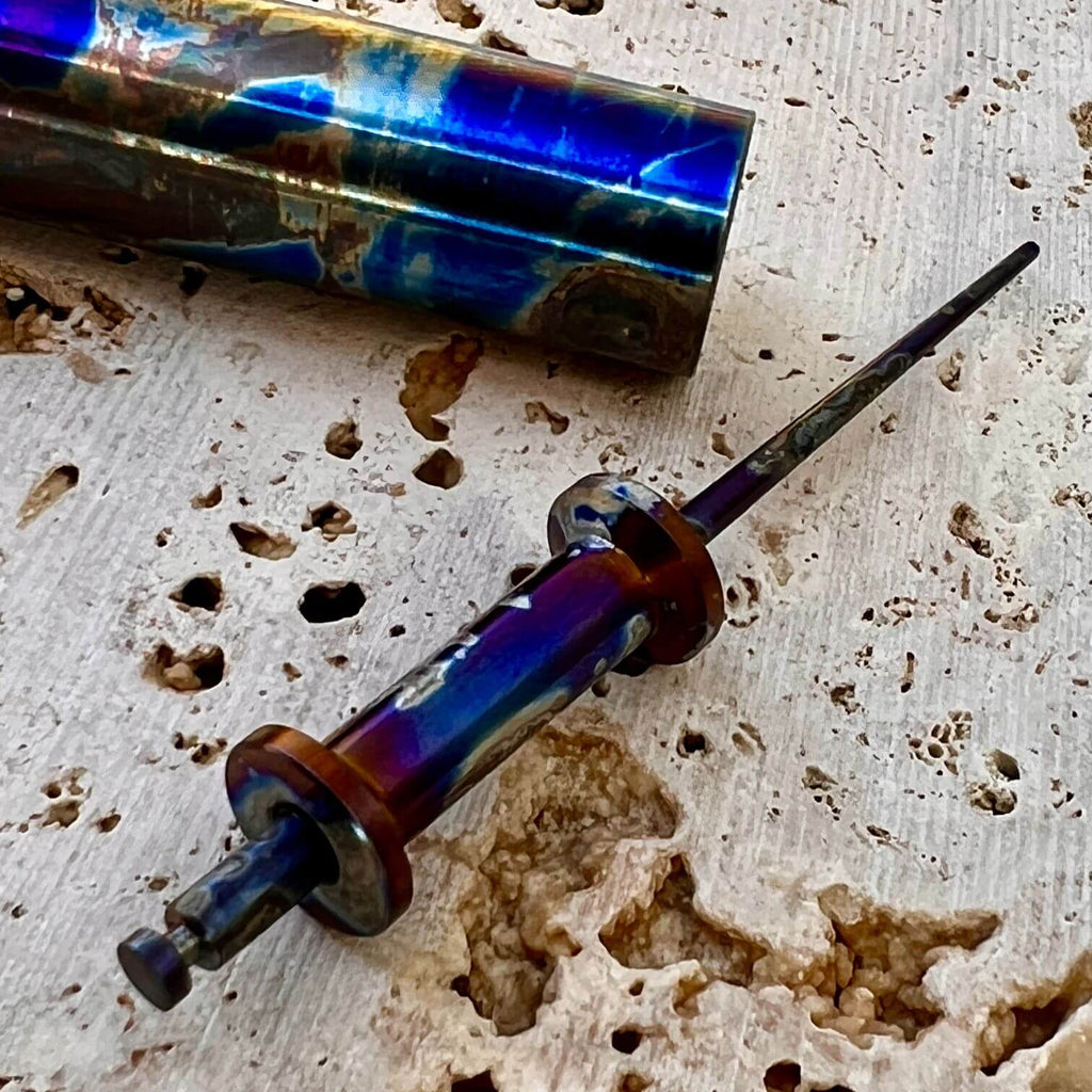 titanium thread bobbin spool with blue smoke anodizing and matching toothpick